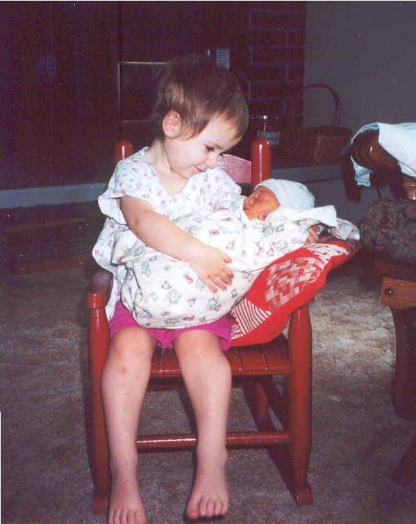 Clara holding her baby brother